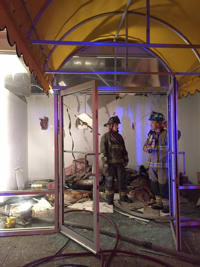 Firefighters work at the former CycleHub space next door to Lyn Belisle Studio